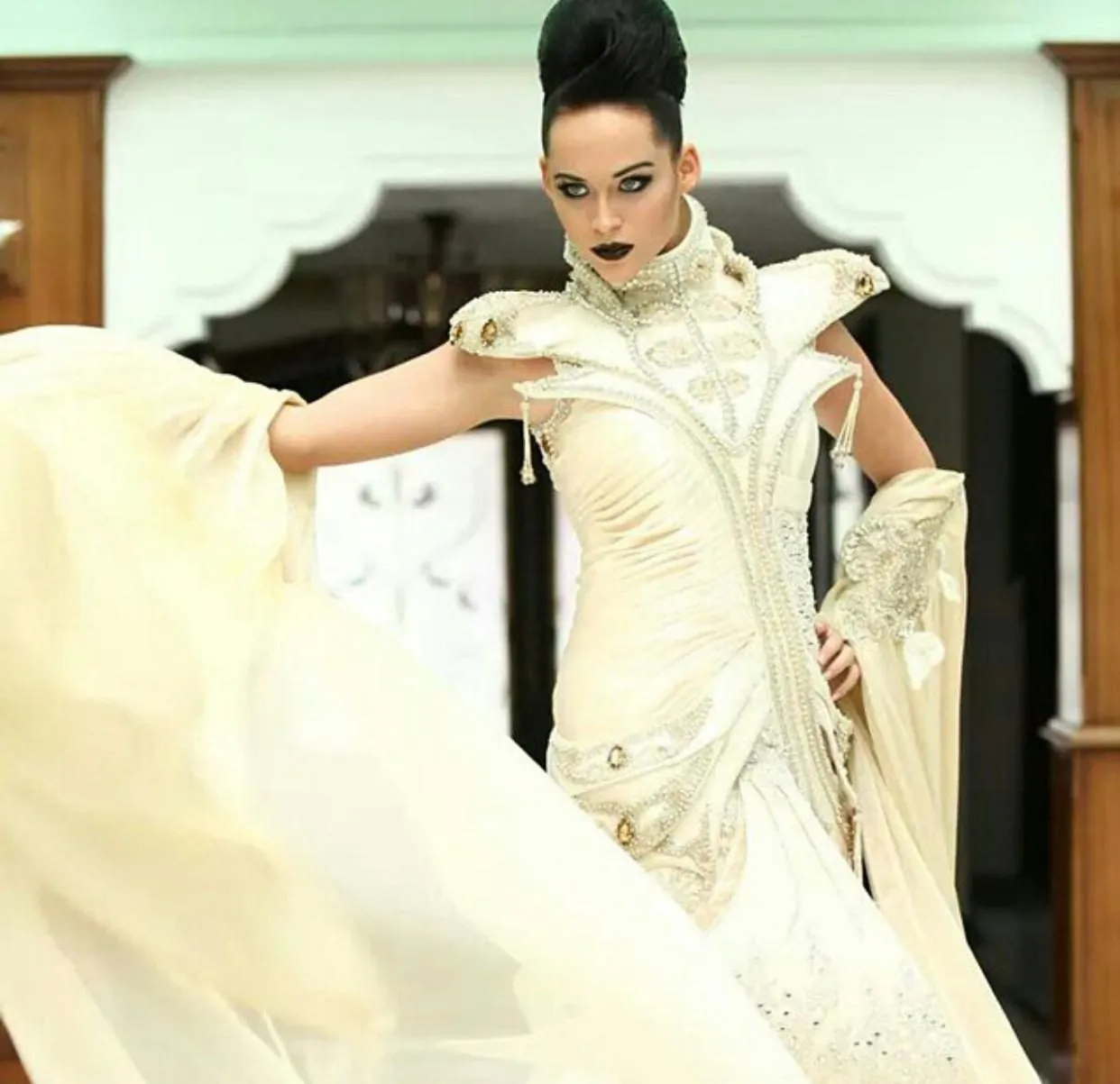 Structured ivory couture gown with jewelled shoulders and beaded collar by Karmen Aksu