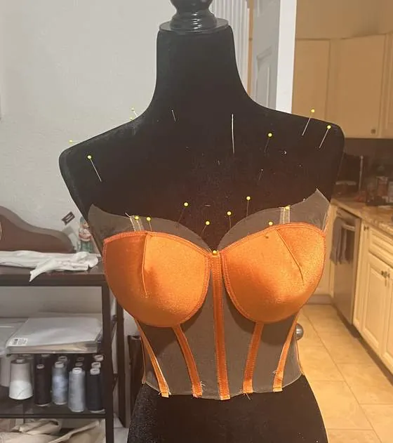 Boned corset pinned on the dress form
